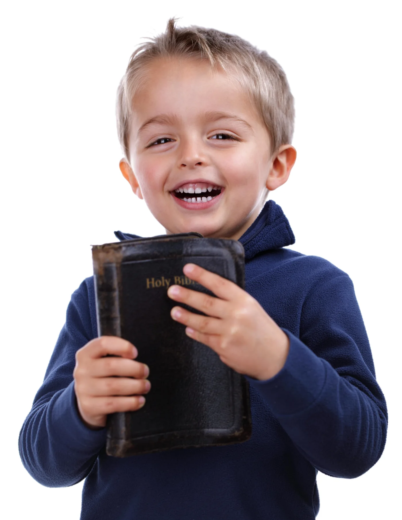 A smiling young child holding a Bible